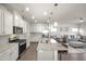 Bright kitchen features granite counters, stainless appliances, and open layout to the living room at 1401 Wrenn Rd, Durham, NC 27703