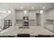 Spacious kitchen features a large island with granite countertops, stainless steel appliances, and modern cabinets at 1401 Wrenn Rd, Durham, NC 27703