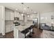 Spacious open-concept kitchen featuring an island with seating, stainless steel appliances, and modern white cabinets at 1401 Wrenn Rd, Durham, NC 27703