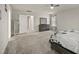 Bright main bedroom with carpeting, dresser, ceiling fan, and ensuite access at 1401 Wrenn Rd, Durham, NC 27703