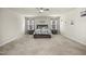 Spacious main bedroom featuring large windows, plush carpet, and a ceiling fan at 1401 Wrenn Rd, Durham, NC 27703