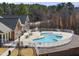 Beautiful community pool with ample seating, surrounded by lush greenery and well maintained fencing at 1401 Wrenn Rd, Durham, NC 27703