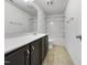 Bathroom with dark cabinets, tub and shower combo, and large mirror at 1419 Glenwater Dr, Cary, NC 27519