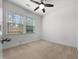 Well-lit bedroom with plush carpet, a ceiling fan, and a large window for a comfortable living space at 1419 Glenwater Dr, Cary, NC 27519