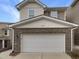Attached two-car garage with white door and brick base on a two-story home at 1419 Glenwater Dr, Cary, NC 27519