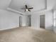 Bright primary bedroom featuring tray ceilings and multiple doorways at 1419 Glenwater Dr, Cary, NC 27519