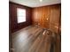 Warm bedroom with wood paneling, wood laminate floors and ample light at 167 Spaulding Dr, Rocky Mount, NC 27801