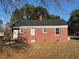 Side exterior view of the brick home showing windows, door and manicured lawn at 167 Spaulding Dr, Rocky Mount, NC 27801