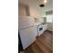 Compact kitchen featuring white appliances, white cabinetry, and laminate flooring at 167 Spaulding Dr, Rocky Mount, NC 27801