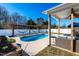 Backyard features pool, hammocks, sitting area, and lush landscaping at 174 Coalyard Dr, Garner, NC 27529