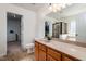 Bathroom with wooden cabinets, a large vanity with sink, and doorway to walk-in closet at 174 Coalyard Dr, Garner, NC 27529