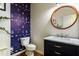 Stylish half bath featuring designer wallpaper, a modern vanity, and a round mirror at 174 Coalyard Dr, Garner, NC 27529