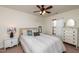 Bedroom with a full bed, ceiling fan, side tables, and a large window providing natural light at 174 Coalyard Dr, Garner, NC 27529