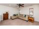 Bonus room featuring large sectional sofa, wooden cabinets and large windows at 174 Coalyard Dr, Garner, NC 27529