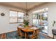Cozy dining area with a wooden table, view of pool, and sliding glass doors at 174 Coalyard Dr, Garner, NC 27529