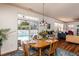 Dining area with a wooden table, sliding glass doors to the pool, and a view to living area at 174 Coalyard Dr, Garner, NC 27529
