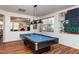 Game room with a pool table, stylish lighting, and ample space for entertaining at 174 Coalyard Dr, Garner, NC 27529
