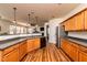 Open kitchen with wooden cabinets and bar overlooking the living area at 174 Coalyard Dr, Garner, NC 27529