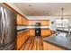 Kitchen featuring wooden cabinets, black appliances, and hardwood flooring at 174 Coalyard Dr, Garner, NC 27529
