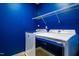 Efficient laundry room with modern appliances and sleek blue accent wall at 174 Coalyard Dr, Garner, NC 27529