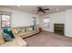 Comfortable living room with ceiling fan, plush carpet, and lots of natural light at 174 Coalyard Dr, Garner, NC 27529