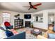 Cozy living room with a fireplace, TV, ceiling fan, and stylish decor at 174 Coalyard Dr, Garner, NC 27529