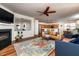 Open concept living area featuring modern decor, hardwood floors, and a fireplace at 174 Coalyard Dr, Garner, NC 27529