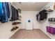 Spacious walk-in closet with shelving on both sides and a chest of drawers in the middle at 174 Coalyard Dr, Garner, NC 27529