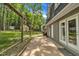 A tranquil backyard featuring a patio, privacy fence, and lush green space at 202 Brook Ln, Durham, NC 27712