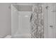 Clean and bright bathroom with shower-tub combo and neutral-toned shower curtain at 202 Brook Ln, Durham, NC 27712