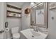 Charming half-bathroom features modern fixtures, stylish mirror, and decorative shelving at 202 Brook Ln, Durham, NC 27712