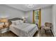 Inviting bedroom with accent chair, bedside lamps, and hardwood floors at 202 Brook Ln, Durham, NC 27712