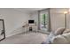 Comfortable bedroom with a seating area, neutral colors, and a large window overlooking the yard at 202 Brook Ln, Durham, NC 27712