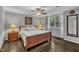 Serene bedroom with a ceiling fan, large window, and hardwood floors at 202 Brook Ln, Durham, NC 27712