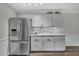 Bright kitchen featuring stainless steel refrigerator and modern, gray cabinetry at 202 Brook Ln, Durham, NC 27712