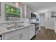 Modern kitchen featuring stainless steel appliances, granite countertops, and a large window at 202 Brook Ln, Durham, NC 27712
