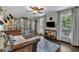 Bright living room featuring custom bookshelves and large windows at 202 Brook Ln, Durham, NC 27712