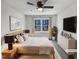 Bright bedroom with a wooden bed frame, ceiling fan, and an outside view at 205 Dwelling Pl, Knightdale, NC 27545