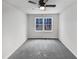 An empty bedroom with gray carpet and a ceiling fan at 205 Dwelling Pl, Knightdale, NC 27545