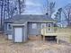 Back exterior showcasing gray siding, deck, and outdoor access at 205 Dwelling Pl, Knightdale, NC 27545
