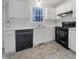 A well-lit kitchen featuring white cabinets and black appliances at 205 Dwelling Pl, Knightdale, NC 27545