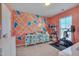 Versatile exercise room with geometric accent wall and abundant storage at 211 Brier Crossings Loop, Durham, NC 27703