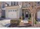 Attractive townhome with a one-car garage, quaint front porch, and manicured landscaping at 211 Brier Crossings Loop, Durham, NC 27703