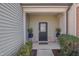 Inviting front entrance with a black door, stone accents, and decorative potted plants at 211 Brier Crossings Loop, Durham, NC 27703