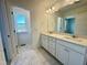 Luxurious bathroom with double vanity, marble countertop, and elegant tile flooring at 26 Twin Birch Dr, Angier, NC 27501