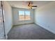 Cozy bedroom features neutral carpet, ceiling fan, and a window overlooking the lawn at 26 Twin Birch Dr, Angier, NC 27501