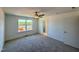 Bright bedroom with plush carpet, ceiling fan, and a window overlooking a playground at 26 Twin Birch Dr, Angier, NC 27501
