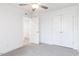 Cozy bedroom with gray carpet, ceiling fan, and doors at 26 Twin Birch Dr, Angier, NC 27501