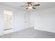 Bright bedroom featuring gray carpet, a ceiling fan, and an ensuite bathroom at 26 Twin Birch Dr, Angier, NC 27501