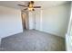 Bedroom featuring a ceiling fan, neutral carpet, and a double-door closet for ample storage at 26 Twin Birch Dr, Angier, NC 27501